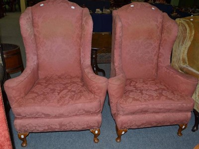 Lot 555 - A pair of Georgian style wing armchairs