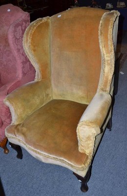 Lot 556 - A Georgian style wing armchair