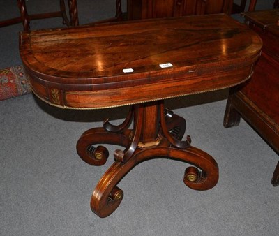 Lot 584 - A Victorian brass strung rosewood fold-over swivel top card table