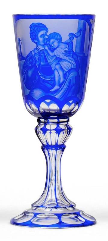 Lot 16 - A Bohemian Blue Flashed Clear Glass Goblet, mid 19th century, the ovoid bowl engraved with a father