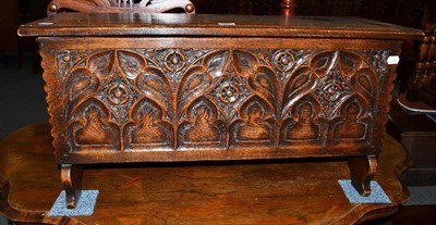 Lot 595 - A reproduction small carved oak coffer