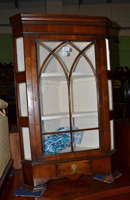 Lot 603 - A walnut glazed corner cupboard