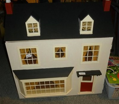 Lot 676 - Painted wooden dolls house (front opening), dolls house furniture and assorted children's records