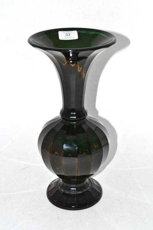 Lot 33 - A Lithyalian Green Glass Vase, mid 19th century, of panelled ovoid form with trumpet neck and...