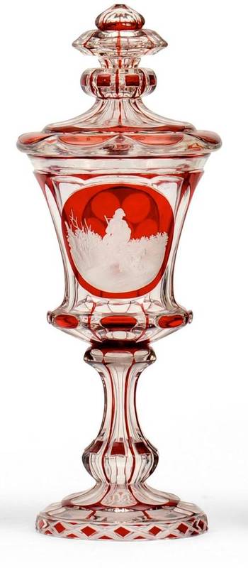 Lot 35 - A Bohemian Ruby Flashed Goblet and Cover, mid 19th century, of panelled form, engraved with a...