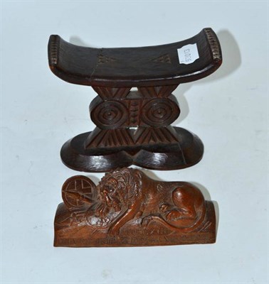 Lot 3 - An African neck rest and a carved lion