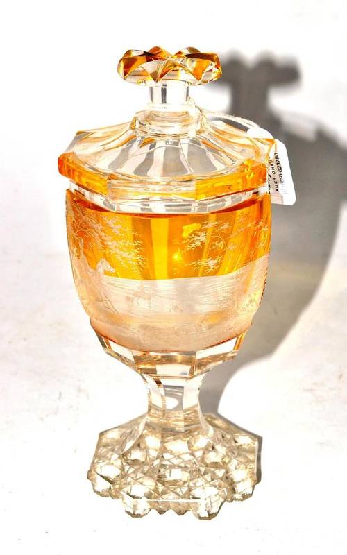 Lot 40 - A Bohemian Amber Flashed Clear Glass Goblet and Cover, mid 19th century, of octagonal form, the...