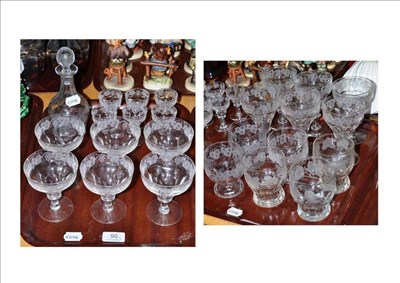 Lot 50 - A suite of cut and engraved glass comprising decanter and twenty four glasses (on two trays)