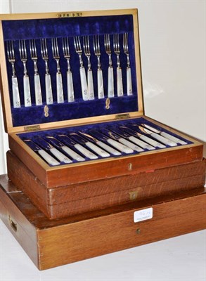 Lot 96 - A set of twelve dessert knives and forks with mother of pearl handles in a mahogany case, a set...