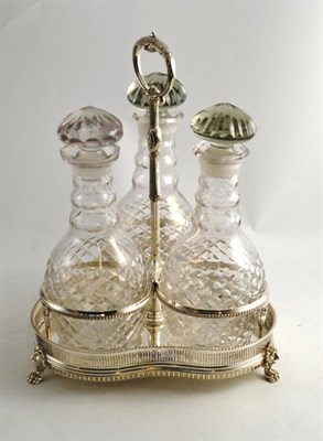 Lot 152 - Three bottle tantalus on a plated stand