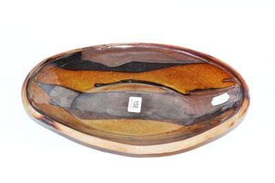 Lot 158 - Michael Cardew, Wenford Bridge Pottery dish decorated with a slip glaze in tones of ochre,...