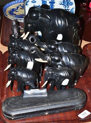 Lot 164 - Seven Indian ebony elephants and a pair of lobster crackers with pick, cased