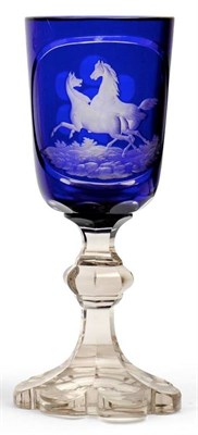 Lot 59 - A Bohemian Blue Overlay Clear Glass Goblet, mid 19th century, engraved with two running horses...