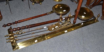 Lot 482 - Two brass warming pans, brass fire set comprising guard, two dogs and three implements