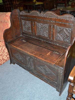 Lot 501 - Carved oak monk's bench