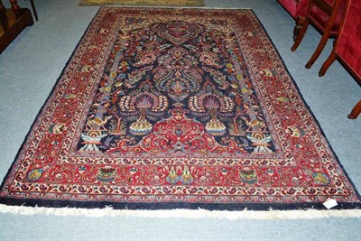 Lot 509 - Kashmir prayer carpet, Khorasan, the abrashed indigo field with hanging lamps and flowers...