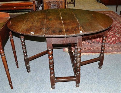 Lot 510 - An 18th century oak gateleg table with bobbin turned legs