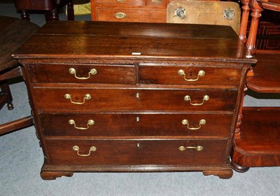 Lot 512 - A George III oak straight front chest of drawers, late 18th century, with two short over three long