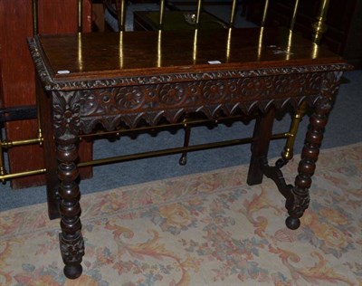 Lot 527 - Carved oak side table