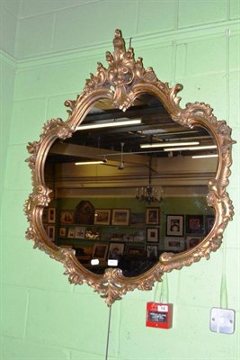 Lot 555 - A gilt mirror