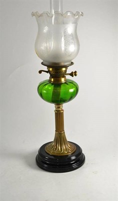 Lot 4 - A brass oil lamp with shade