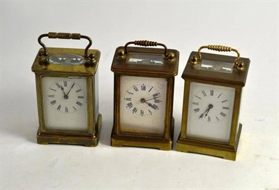 Lot 39 - Three brass carriage timepieces with black Roman numerals (3)