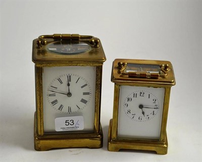Lot 53 - A brass carriage timepiece with black Roman numerals and a similar smaller carriage timepiece...