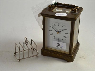 Lot 59 - Two train carriage clock by Matthew Norman, London and a silver small toast-rack