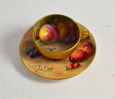 Lot 63 - A Royal Worcester small cabinet cup and saucer painted with fruit and signed Ricketts and Rushton