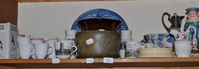 Lot 64 - A shelf of decorative ceramics and glass including a Ruskin mottled glaze bowl, a mottled red...