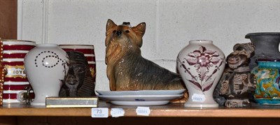 Lot 73 - A shelf of decorative ceramics including a figure of a Yorkshire Terrier, a pair of tin glaze...