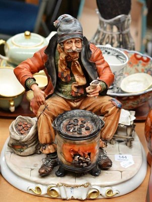 Lot 144 - A large Capodimonte figure of a man roasting chestnuts