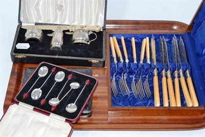 Lot 156 - A cased silver condiment set; two cased sets of six bean end coffee spoons; a cased set of...