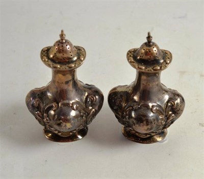 Lot 182 - A pair of pepperettes, early 20th century with Chester hallmarks, 2cm high, 3 ounces...