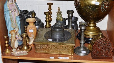 Lot 200 - A shelf of ornamental items including brass and pewter candlesticks, pewter capstan inkwell,...