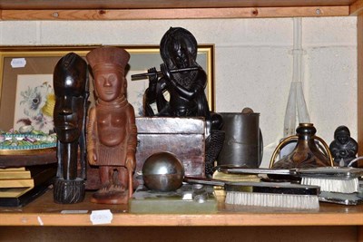 Lot 203 - A shelf of ornamental items including tea caddy, botanical prints, tribal figures, inkwell,...