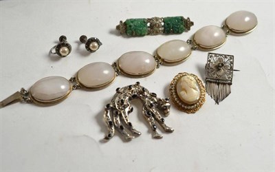 Lot 214 - Costume jewellery comprising a marcasite set cat brooch, a white agate bracelet, a jade type...