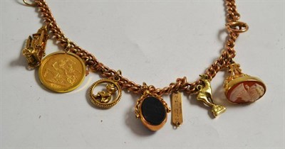 Lot 237 - Rose gold albert converted to a bracelet hung with seven charms including a 1907 loose mounted full