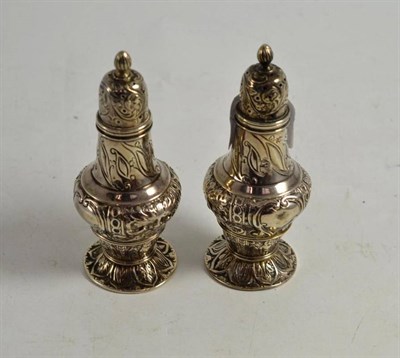 Lot 315 - A pair of victorian silver pepperettes, London 1888, with all over repousse decoration