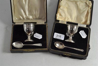 Lot 316 - Two silver egg cups and spoons, cased