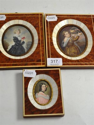 Lot 317 - Amboyna and ivory framed miniature of a young girl holding a plate of fruit, and two others...