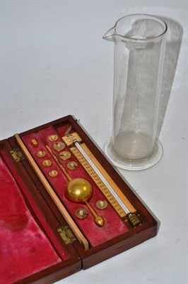 Lot 324 - A Sikes Hydrometer, cased and a glass measuring vessel (a.f.)