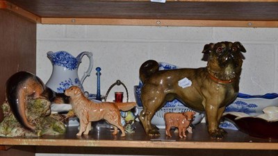 Lot 344 - A shelf of decorative ceramics including a large figure of a Pug dog, a Beswick Golden Retriever, a