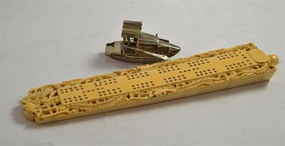 Lot 362 - A Chinese export carved elephant ivory cribbage board circa 1920 and a white metal sampan (2)