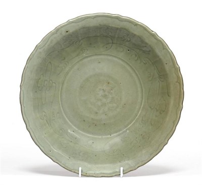 Lot 132 - A Longquan Celadon Glazed Dish, Ming Dynasty, of fluted circular form, carved with stylised...