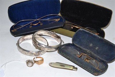 Lot 374 - Three pairs of spectacles, two silver bangles, a silver penknife and two rings (8)