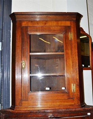 Lot 500 - A glazed corner cupboard and two mirrors