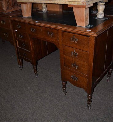 Lot 518 - An oak small knee hole desk