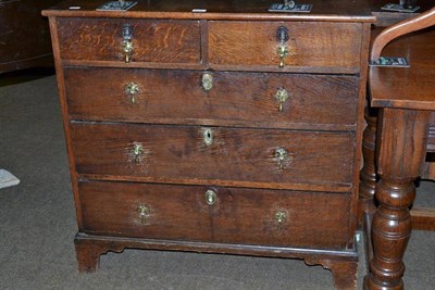 Lot 541 - An 18th century oak straight fronted chest of drawers of two short over three long drawers...