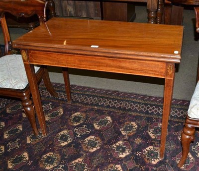 Lot 545 - A mahogany fold over tea table